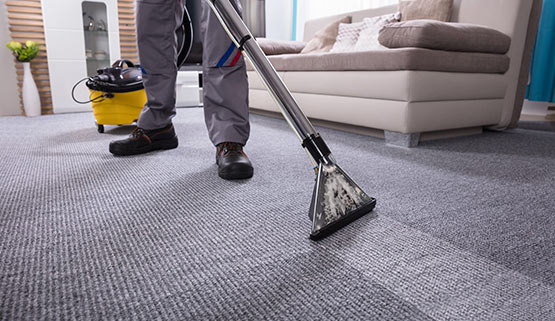 worker cleaning carpet